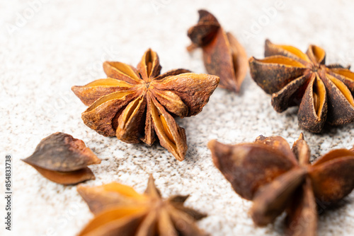 Spice star anise closeup on gray stone background photo