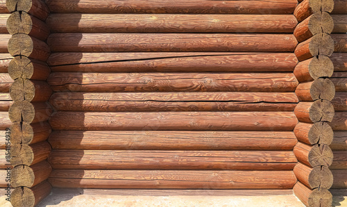 A log wall construction with a swedish cope log profile. Heavily cracked brown wall of a blockhouse as a background
