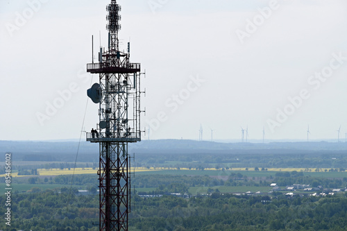 A 95 m high transmitter mast. Aerial view of mobile phone cell tower over forested rural area. Radio and Television Broadcasting Center. A station transmitting radio and television waves. 