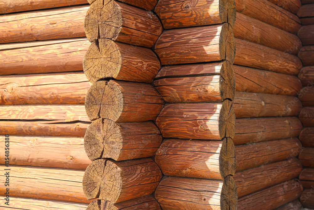 A log wall construction with a swedish cope log profile. Corner of the old blockhouse. Photo with selective focus A log wall construction with a swedish cope log profile. Corner of the old blockhouse. Photo with selective focus