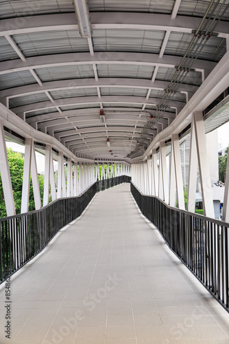 Pedestrian pathway or corridor or hallway between train station and building.	