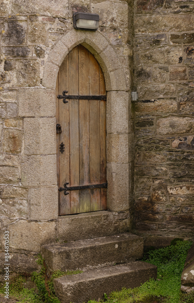 old wooden door in a stone wall old wooden door in a stone wall