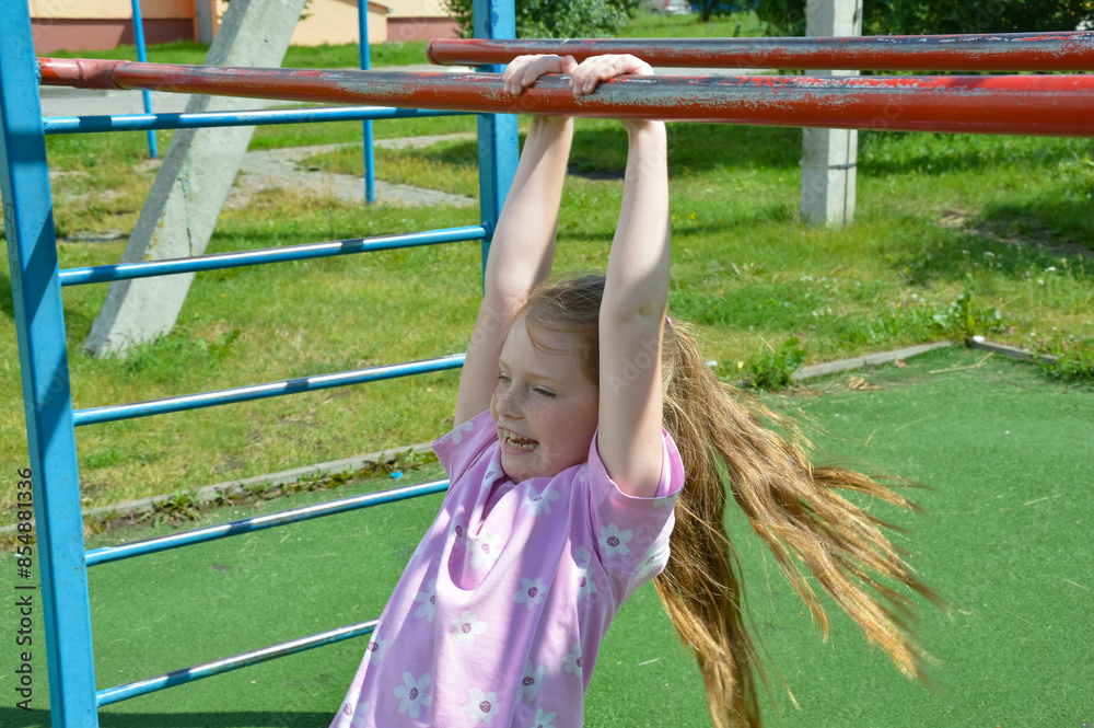 the girl is playing sports on the playground. summer games in the park. background for the design. the girl is playing sports on the playground. summer games in the park. background for the design.