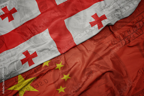 Photography waving colorful flag of georgia and national flag of china on the dollar money background