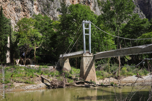 The destroyed footbridge (suspension bridge) over the river Pinios in the Tempe Valley - Greece 2024 photo