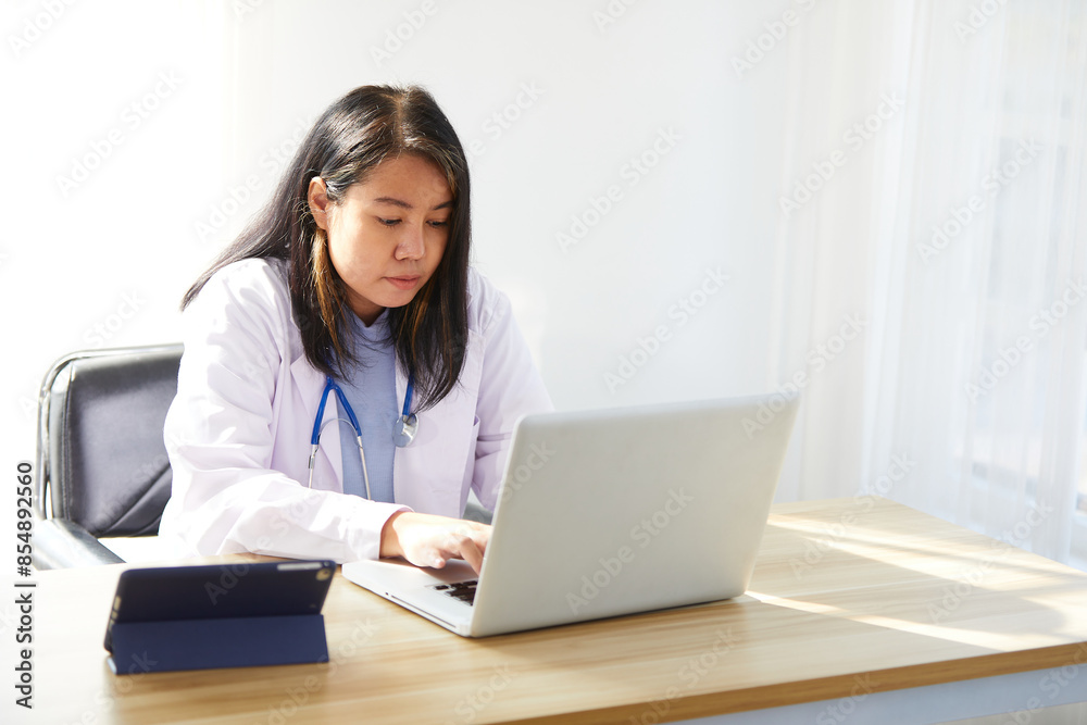 female doctor working on laptop computer in the hospital female doctor working on laptop computer in the hospital