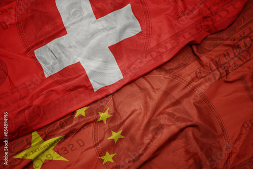 Canvas Print waving colorful flag of switzerland and national flag of china on the dollar money background