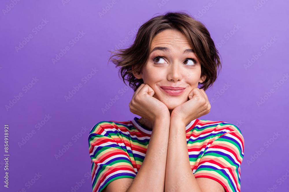 Photo of adorable creative minded person hands touch cheeks look empty space isolated on violet color background Photo of adorable creative minded person hands touch cheeks look empty space isolated on violet color background