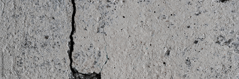 Texture of old cracked concrete wall. Rough gray concrete surface. Wide panoramic background for design. Texture of old cracked concrete wall. Rough gray concrete surface. Wide panoramic background for design.