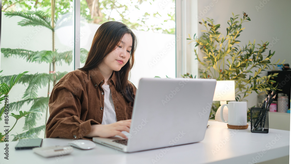 Beautiful young entrepreneur working with laptop at home office. Beautiful young entrepreneur working with laptop at home office.