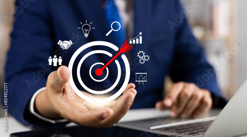 Concept of business strategy and future sustainable business finance action plan. Hand holding target board for creative and set up business objective target and success and business goals concept.