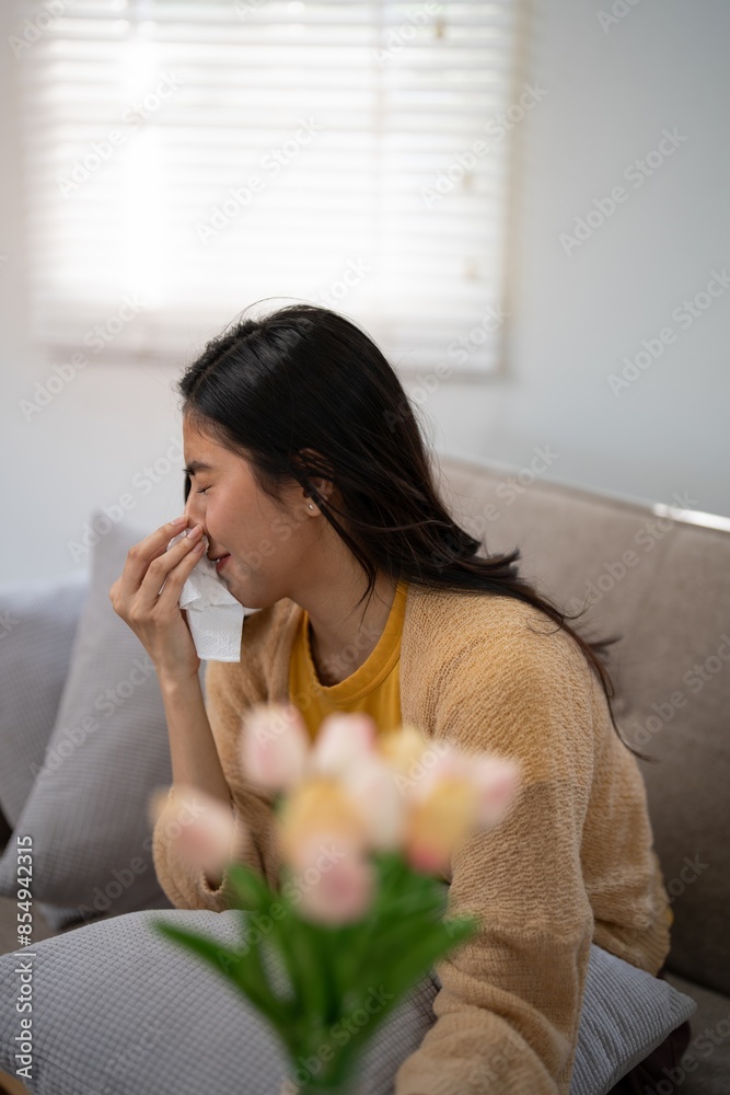 Woman sneezing due to pollen allergy at home. Concept of seasonal allergies Woman sneezing due to pollen allergy at home. Concept of seasonal allergies