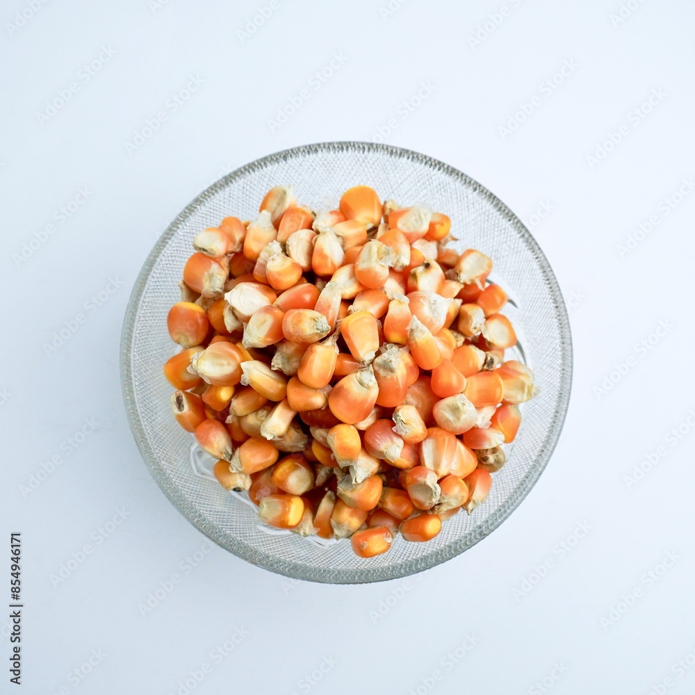 Groups of dry yellow corns in glass bowl food ingredients photography isolated on above top angle view horizontal ratio white background. Groups of dry yellow corns in glass bowl food ingredients photography isolated on above top angle view horizontal ratio white background.