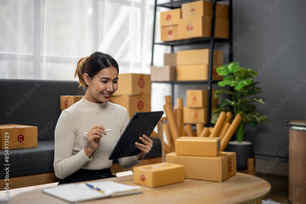 A woman is sitting at a desk with a tablet in front of her A woman is sitting at a desk with a tablet in front of her