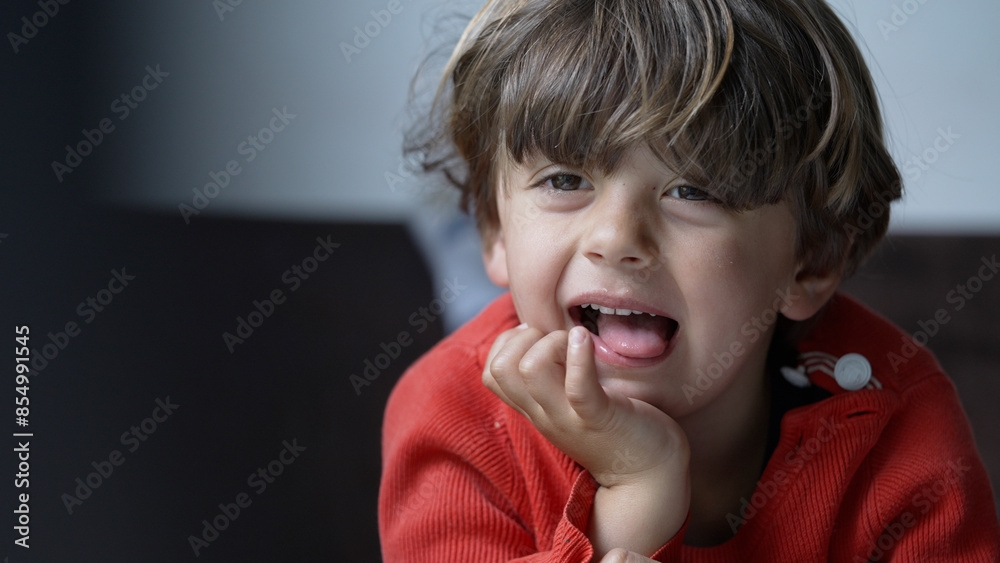Playful Young Boy Laughing and Showing Tongue in Close-Up Portrait Playful Young Boy Laughing and Showing Tongue in Close-Up Portrait