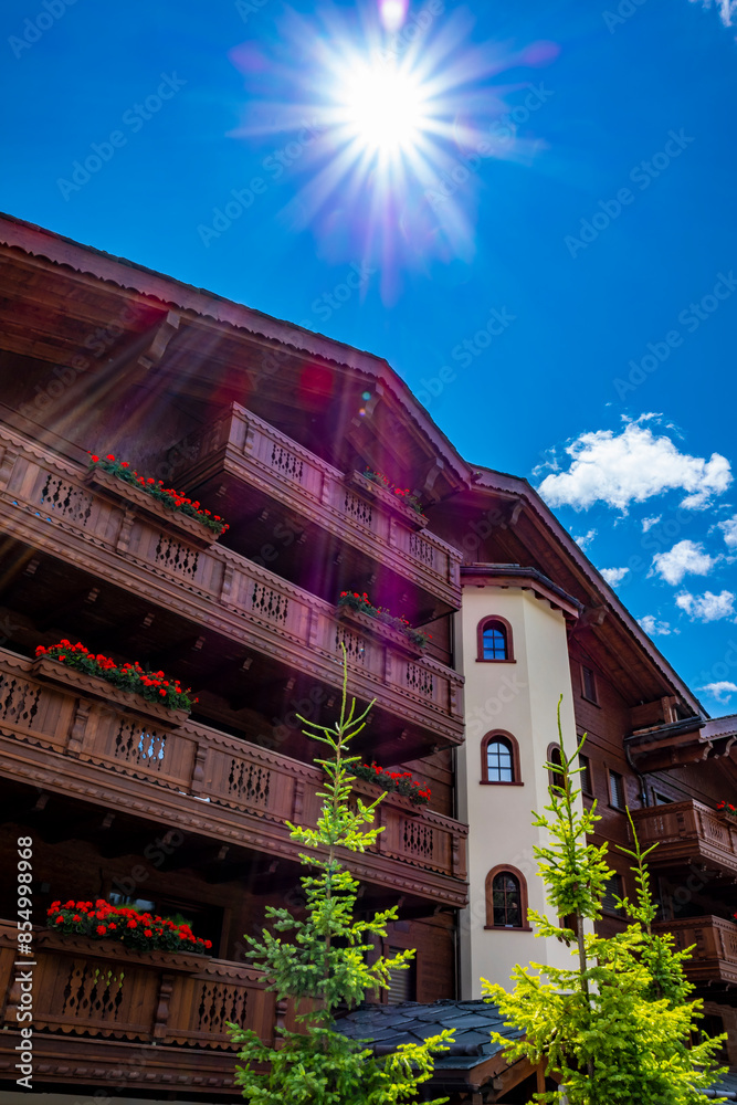 Wood Building with Balcony and Flower and Sunbeam in Crans Montana, valais in Switzerland.