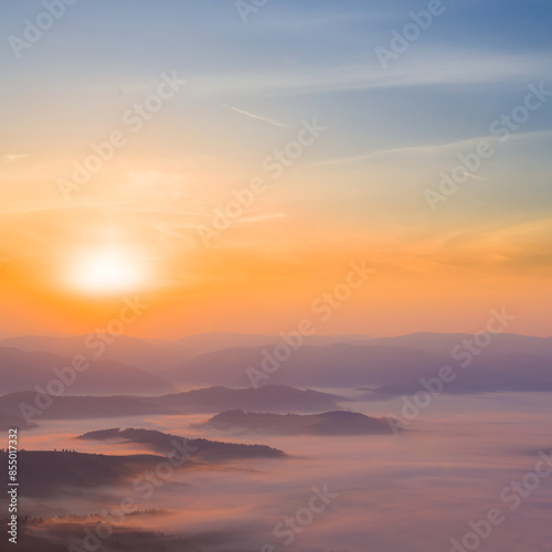 Fototapeta Naklejka Na Ścianę i Meble -  mountain chain silhouette in dense mist at the sunrise