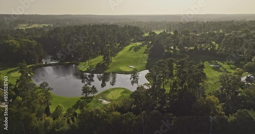 Augusta Georgia Aerial v59 cinematic drone flyover around the National Golf Course, capturing sunset views of the lush fairways, lake, and cityscape - Shot with Mavic 3 Pro Cine - October 2023