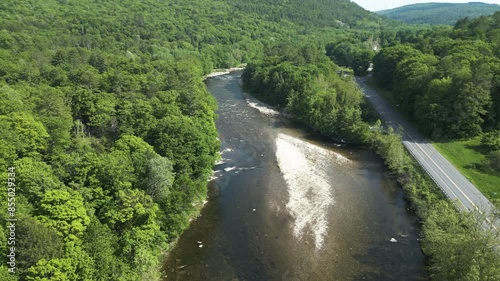 Panoramic view of shallow West River in between lush foliage in West Dummerston, Vermont -aerial drone shot photo