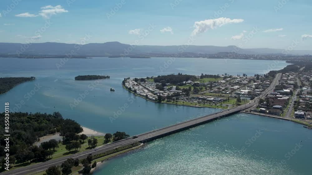 Windang Bridge connects city, aerial dolly to Lake Illawarra on beautiful sunny day Windang Bridge connects city, aerial dolly to Lake Illawarra on beautiful sunny day