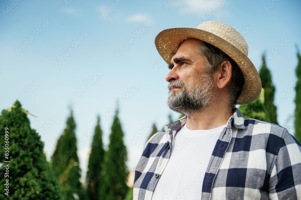 Beautiful portrait. Senior gardener is at work at daytime Beautiful portrait. Senior gardener is at work at daytime