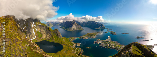  view of the rugged mountains and coastline of Norway, with clear blue skies and white clouds. The image captures the stunning beauty of this Scandinavian country. Reinebringen hike Lofoten Norway photo