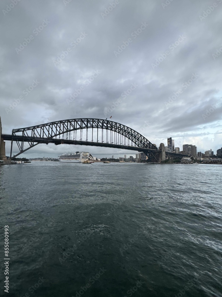 View of Sydney Harbour Bridge with a cloudy sky over Sydney Harbour, Australia. View of Sydney Harbour Bridge with a cloudy sky over Sydney Harbour, Australia.