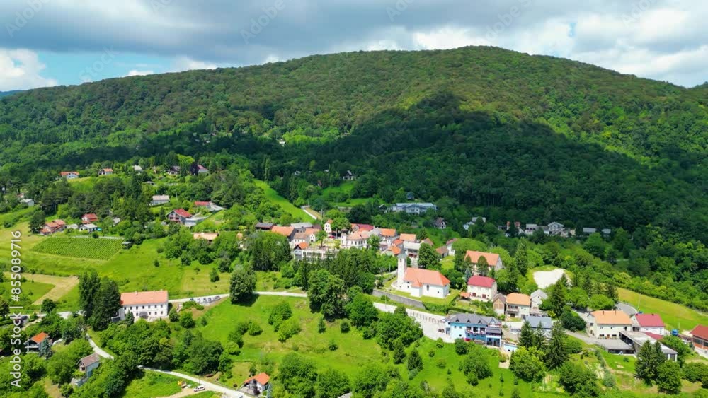 Aerial photos captures the beautiful fields of the Plešivica (Plesivica) wine region in Croatia. The image showcases picturesque hills covered with vineyards and cozy village Aerial photos captures the beautiful fields of the Plešivica (Plesivica) wine region in Croatia. The image showcases picturesque hills covered with vineyards and cozy village