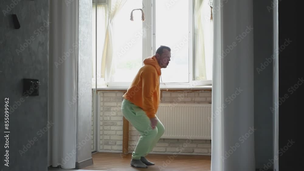 Home style dancing in a cheerful mood, modern creative dancer at home. A young guy practices modern dancing to music
