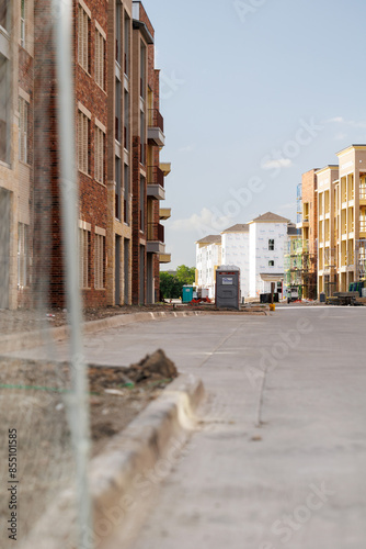 An apartment complex site under construction with multi-story buildings in various stages of construction.