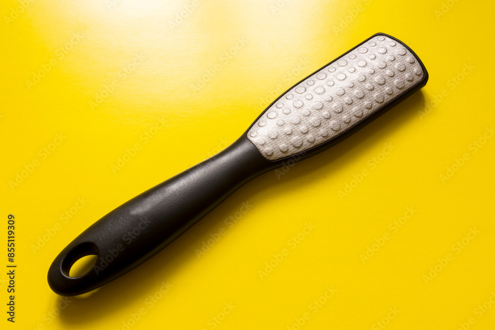 Foot brush close-up on a yellow background.
Foot brush close-up on a yellow background.