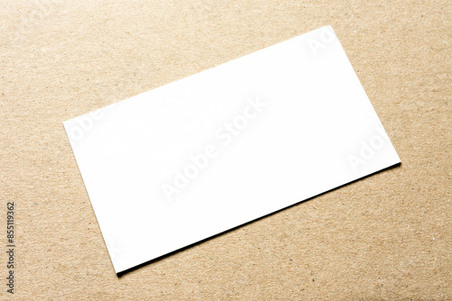 White card on a cardboard background close-up. 