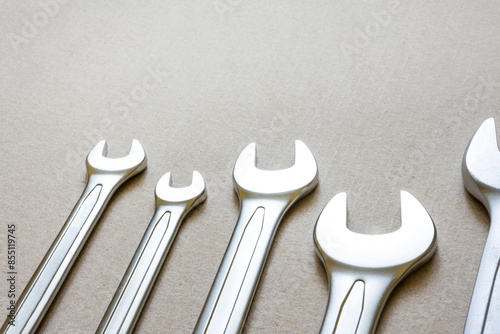 Wrenches on a cardboard background.