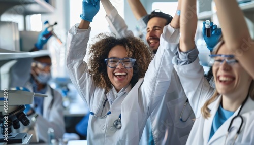 Group of excited scientists celebrating their success in the laboratory.