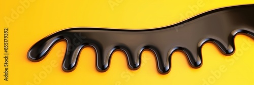 Abstract black liquid oil stain on bright yellow background. Place for text.
