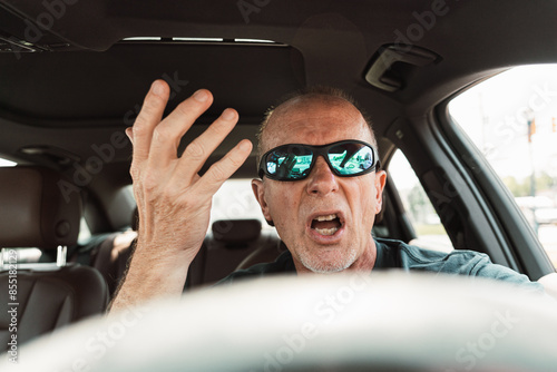 older man in a car upset with drivers and traffic