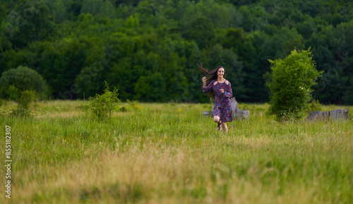 Gorgeous hispanic young woman on a meadow with oak forest © Xalanx