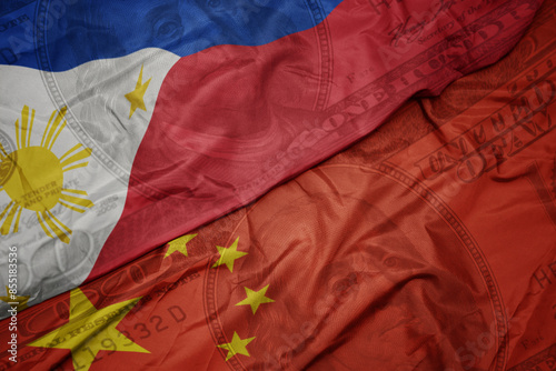 Photography waving colorful flag of philippines and national flag of china on the dollar money background