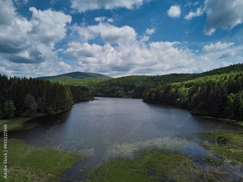 Lake Trei Ape Three Waters photographed from a drone flight. The blue sky with clouds and green forests. Lake Trei Ape Three Waters photographed from a drone flight. The blue sky with clouds and green forests.