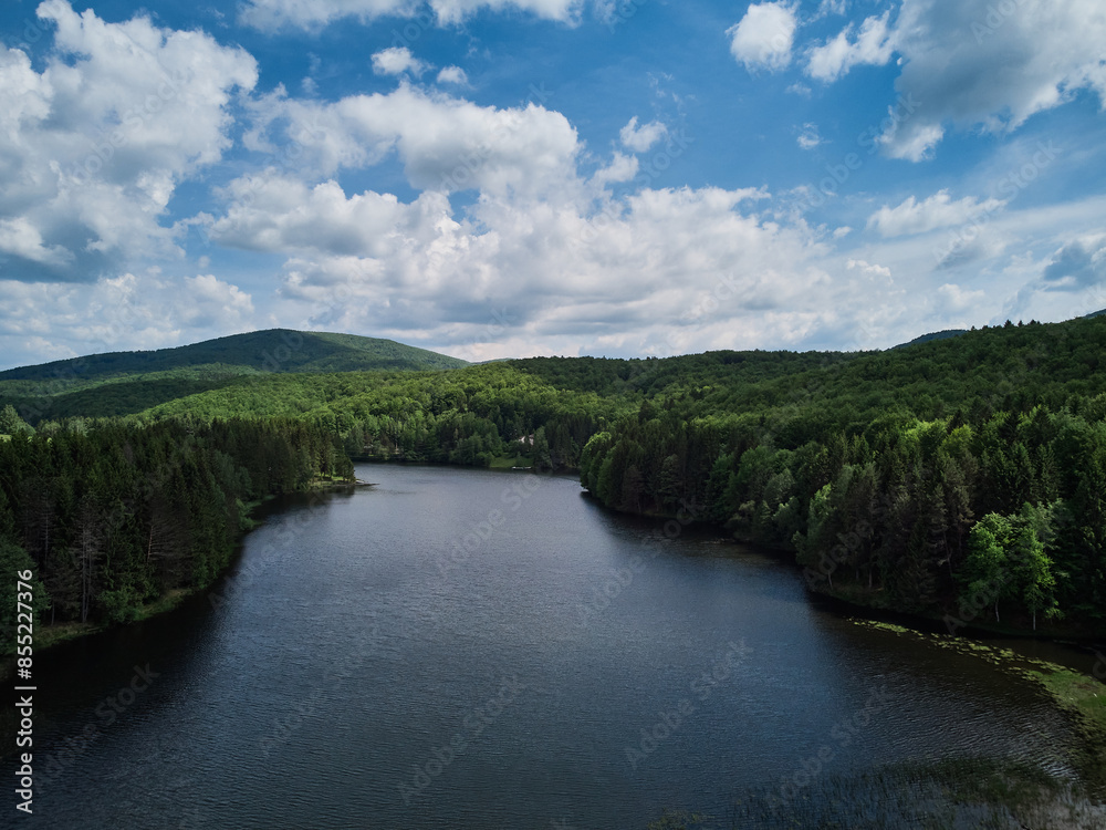 Lake Trei Ape Three Waters photographed from a drone flight. The blue sky with clouds and green forests. Lake Trei Ape Three Waters photographed from a drone flight. The blue sky with clouds and green forests.