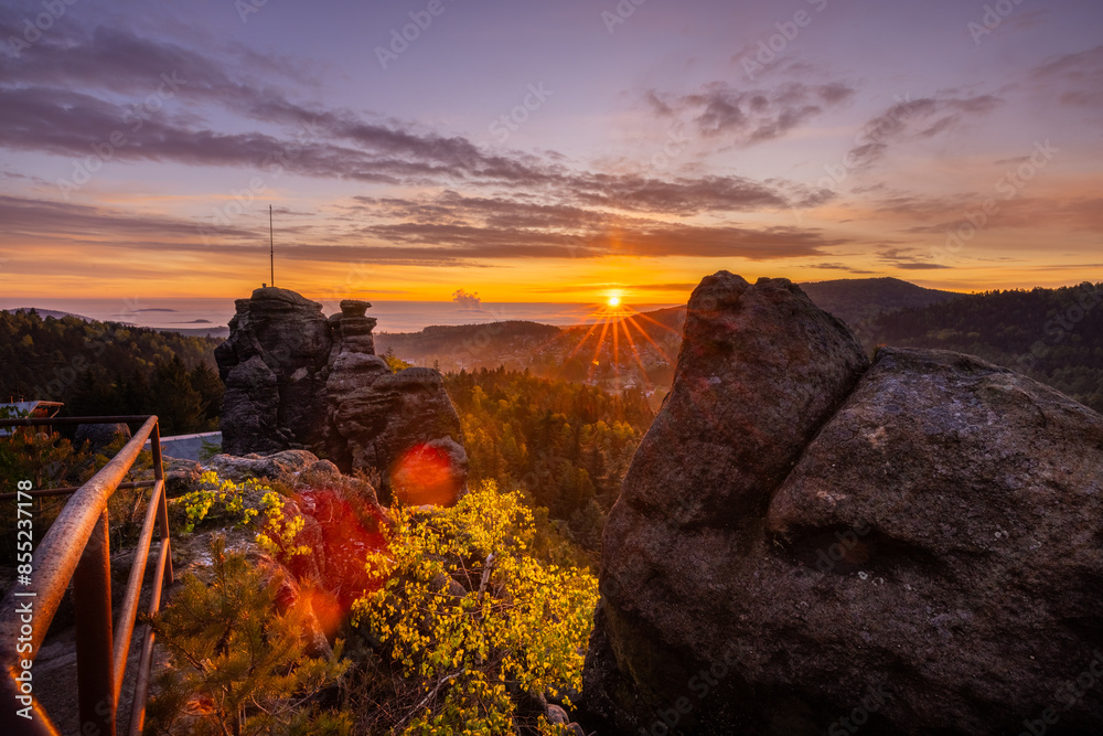 Sunrise with fog on the Nonnenfels mountain in Zittauer Gebirge Sandstone golden hour golden light afterglow skyglow red sky sunstar against sun