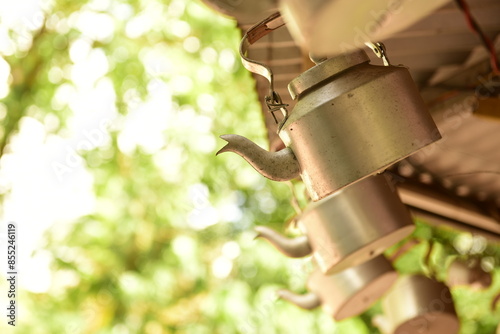 Tea kettles hanging outside a tea shop in India as a decorative signage to attract customers