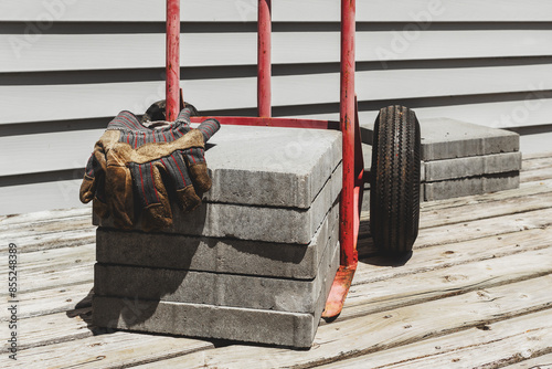 Hand truck or dolly and cement blocks on house deck