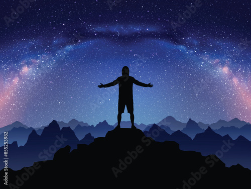 Night climbing. Man with outstretched arms on top of rocky mountain