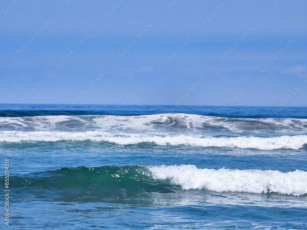 View of the sea with many waves on a nice day with clear and sunny skies. View of the sea with many waves on a nice day with clear and sunny skies.