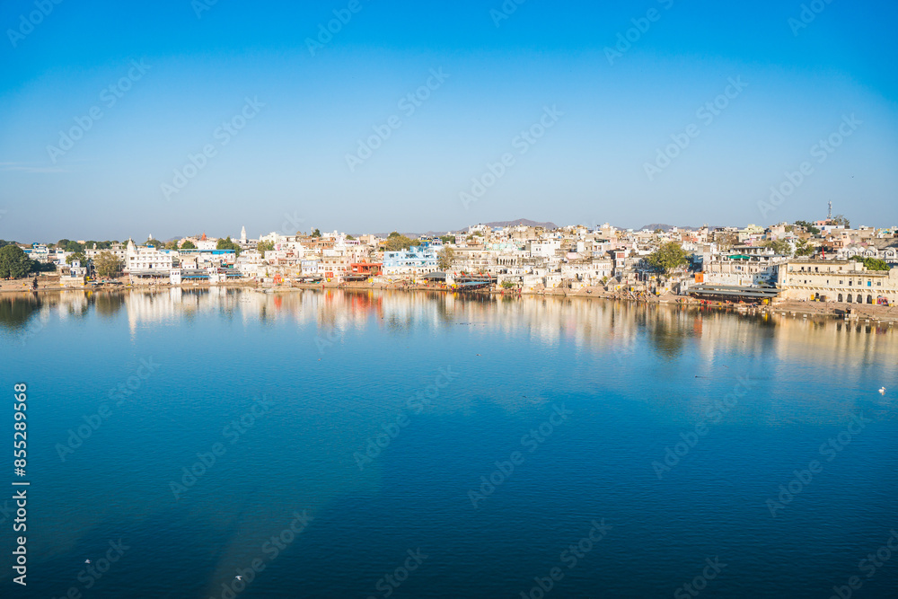 A serene lake stretching out with a majestic mountain in the distance, Pushkar, Rajasthan, India A serene lake stretching out with a majestic mountain in the distance, Pushkar, Rajasthan, India