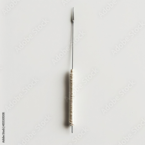 single acupuncture needle thin metallic handle alternative medicine plain background