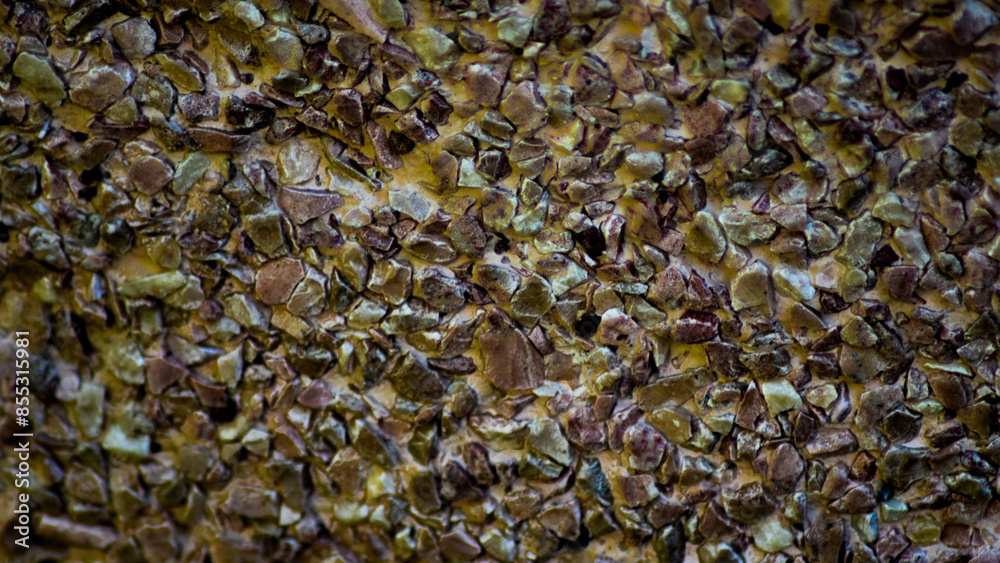 Wall surface made of brown pebbles, background Wall surface made of brown pebbles, background