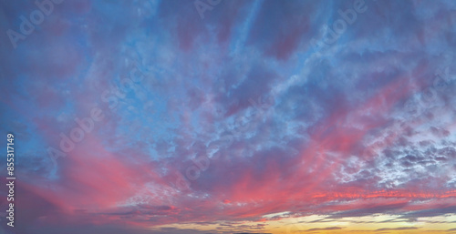 Real amazing panoramic sunrise or sunset sky with gentle colorful clouds. Long panorama.