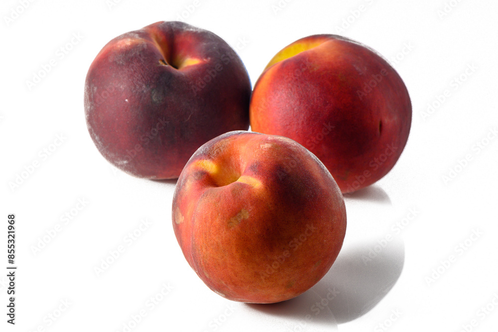 Three fresh peaches with leaves and drops of water Three fresh peaches with leaves and drops of water